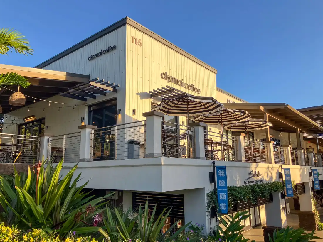 Akamai Coffee at Wailea Village in Wailea, Maui, with striped umbrellas on its upper terrace