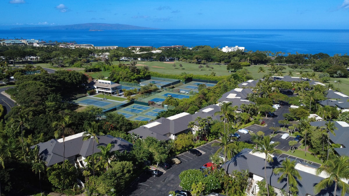 Aerial view of Grand Champions Villas with the Wailea Tennis Club and the ocean beyond
