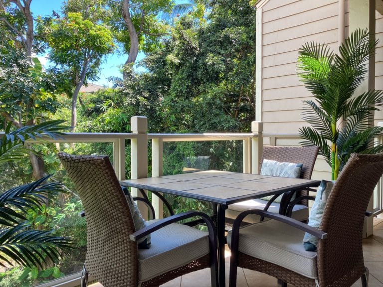 Private lanai with dining table and garden view at a Wailea vacation condo